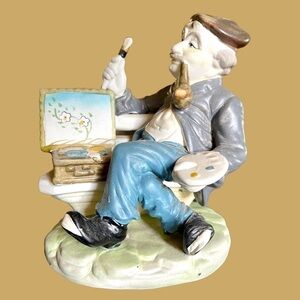 6 1/2”H X 5 3/4”W X 4 1/4”D. Porcelain Artist Statue. No Chips or Breaks.